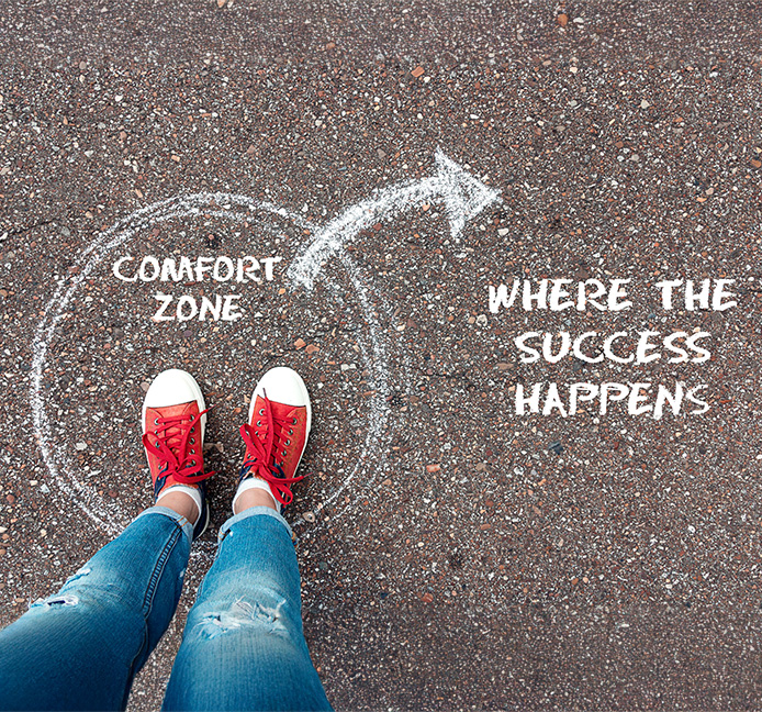 Wooden signpost displaying directions with words Unlock Full Potential against a dramatic sunset sky showcasing nature's beauty and inspiration for personal growth and self-improvement.